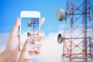 hand hold mobile smartphone with telecommunication tower