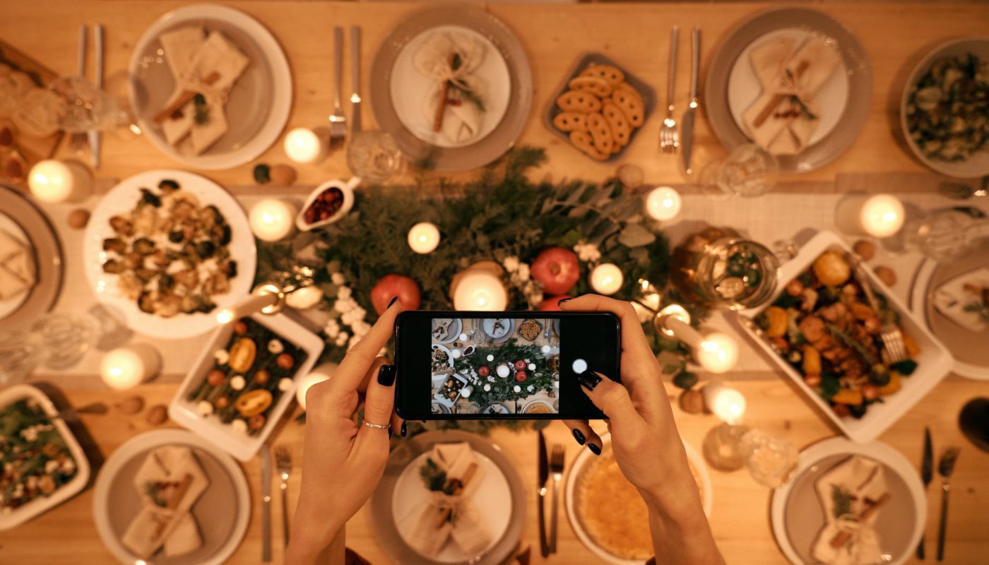top view of a person taking picture of christmas dinner