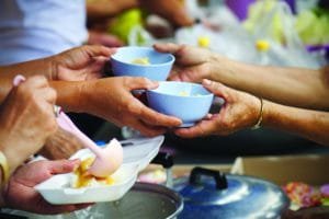 Rich people give food to the poor. starvation concept