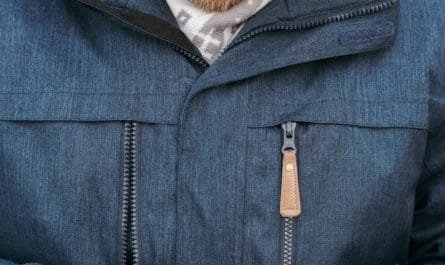 smiling guy making online payment with credit card and mobile phone