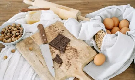 brown wooden chopping board with knife and white textile