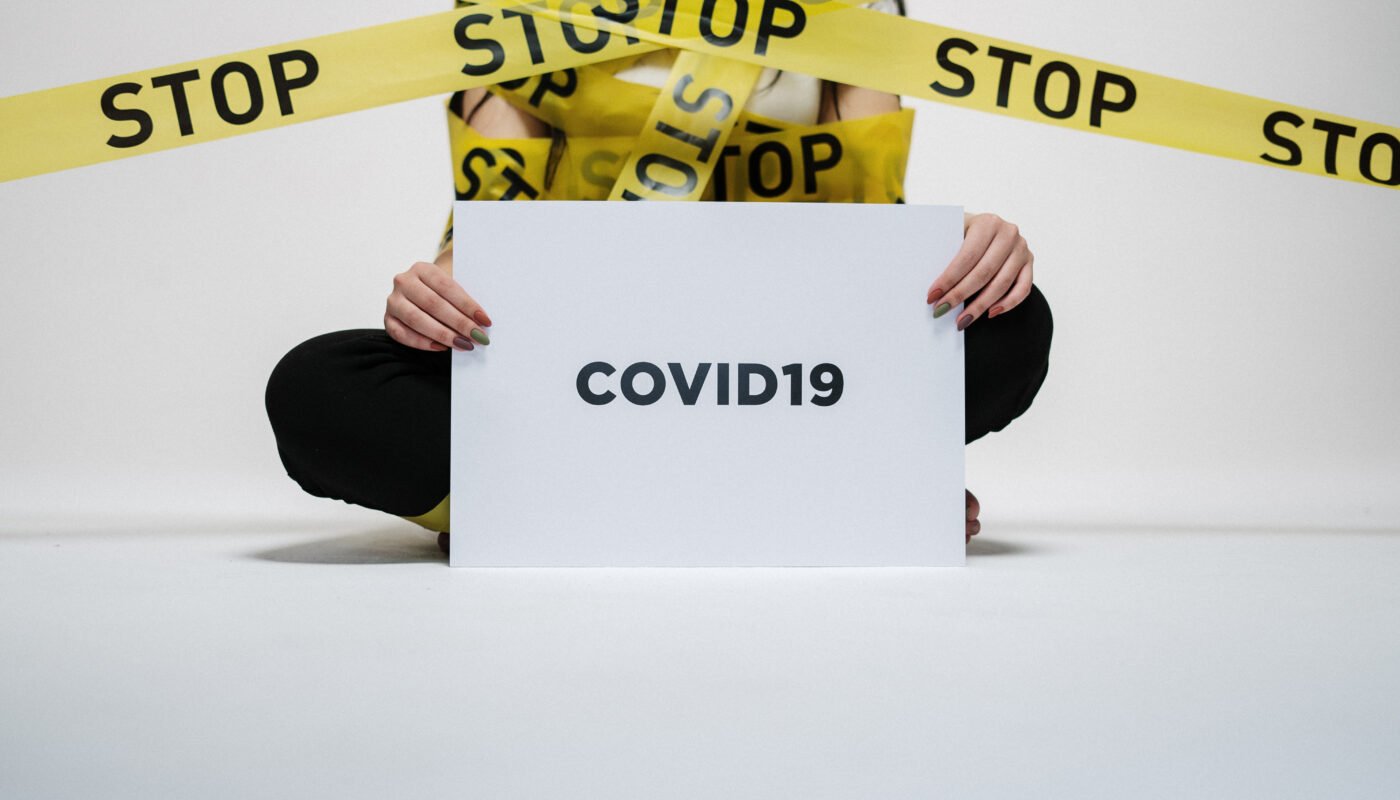 Person holding covid sign
