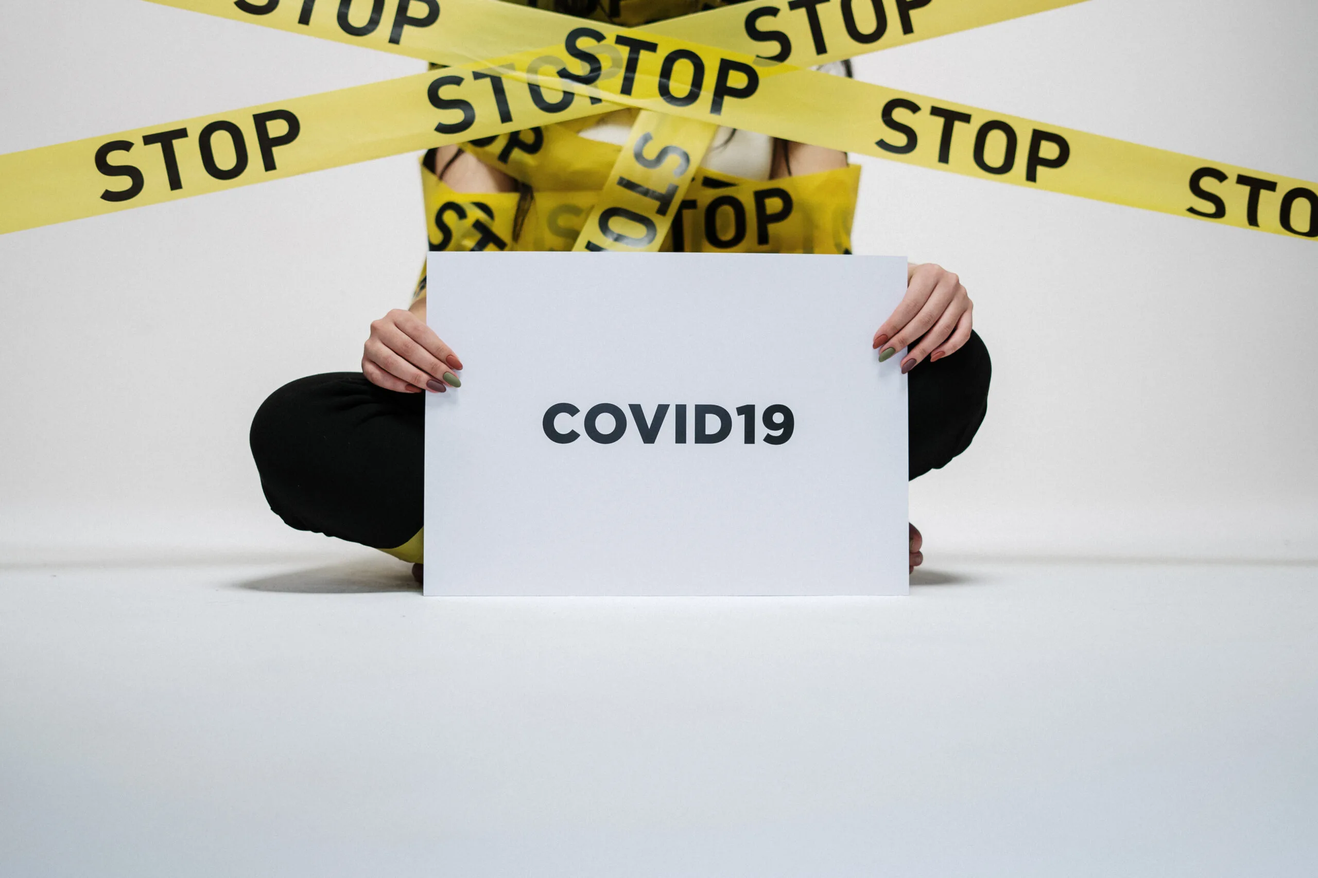 Person holding covid sign