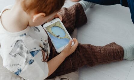 little child playing game on mobile phone